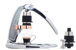 metal espresso machine with mug below, full view on bottom right