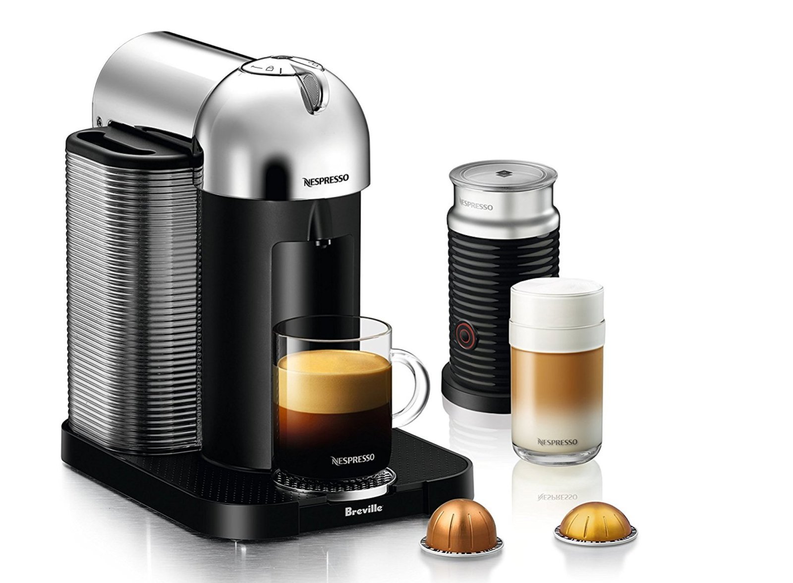black espresso coffee maker with silver top, cup of coffee, two pods, latte and thermos to the right